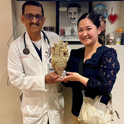 NhuTran perfusonist holding golden crochet heart